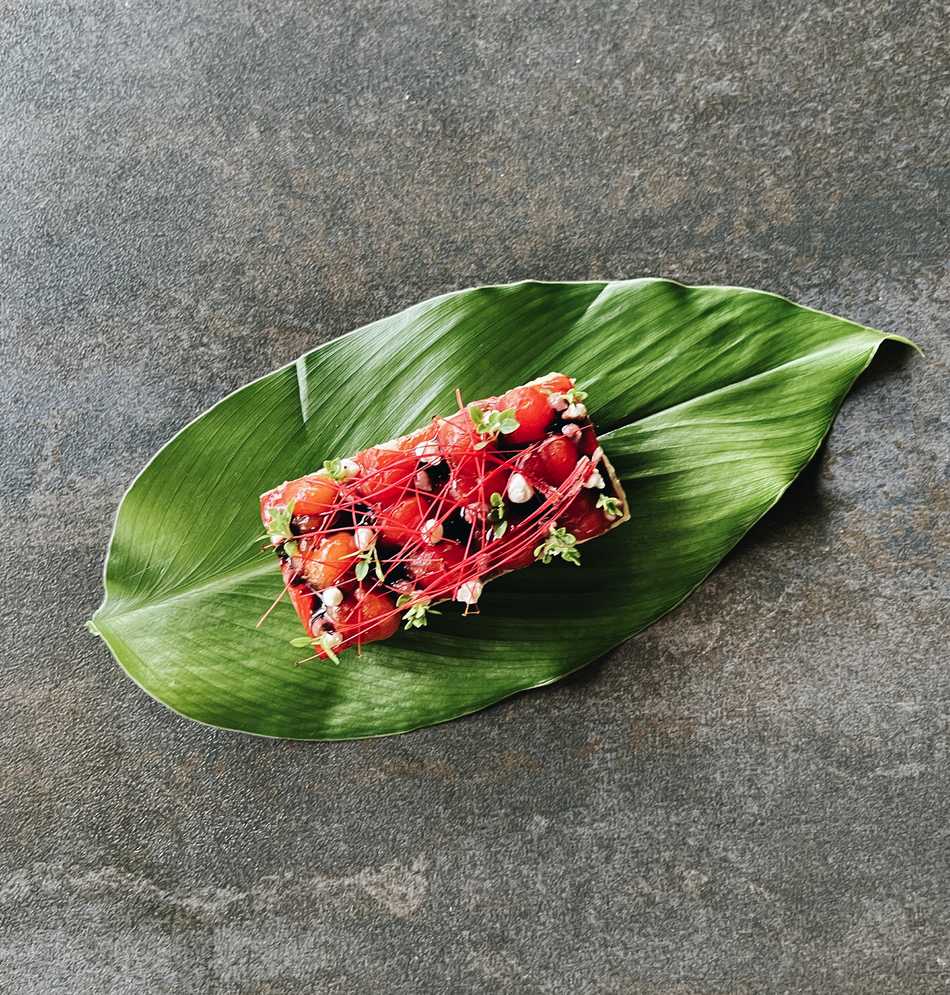 A regenerative gastronomy dish plated on a leaf